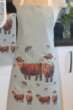 Load image into Gallery viewer, close up of apron with highland cow design

