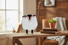 Load image into Gallery viewer, Handmade fused glass sheep art piece styled on a wooden shelf with books and botanicals — a unique gift for nature lovers
