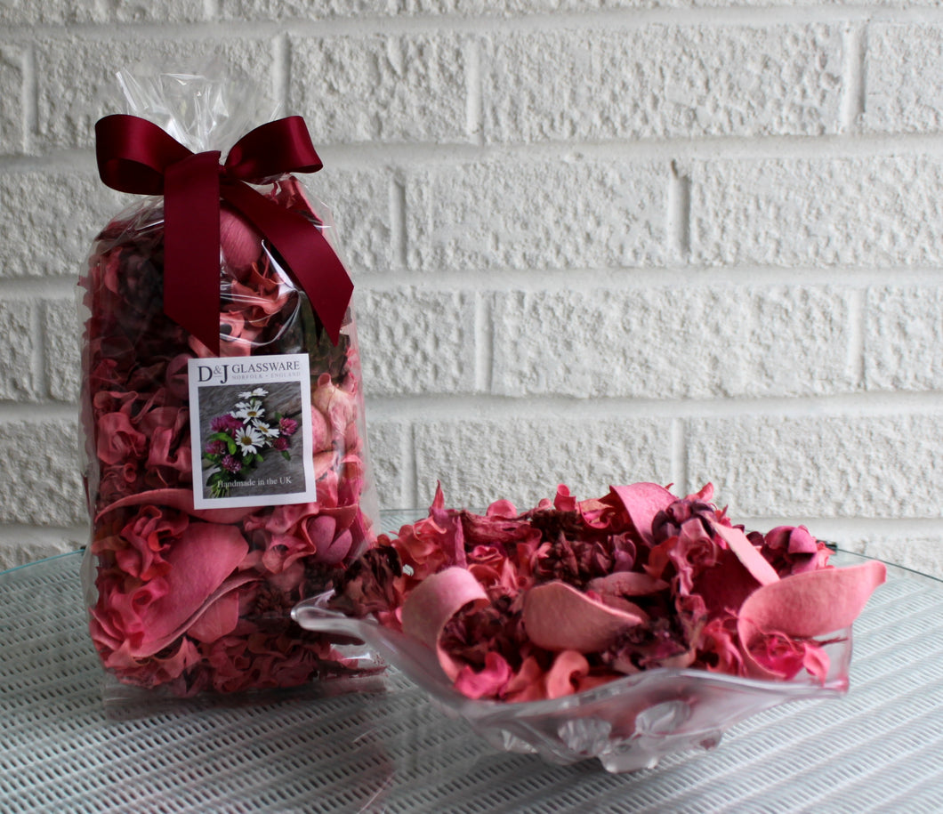 A bag of Rose Garden pot pourri next to a bowl with some pot pourri.